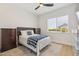 Bright bedroom features a checkered blanket, ceiling fan, and neutral-toned walls at 3356 E Vallejo Ct, Gilbert, AZ 85298