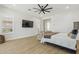 Inviting bedroom features a ceiling fan, light wood floors, natural light, and a seating area at 3356 E Vallejo Ct, Gilbert, AZ 85298