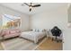 Bedroom featuring a bed with a patterned comforter and a pink loveseat at 3356 E Vallejo Ct, Gilbert, AZ 85298