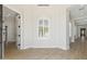 Spacious entryway featuring arched window, wood-look floors, and white walls at 3356 E Vallejo Ct, Gilbert, AZ 85298