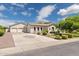Spacious home with three-car garage and long driveway, complemented by lush landscaping at 3356 E Vallejo Ct, Gilbert, AZ 85298