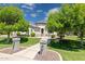 Inviting home featuring well-maintained lawn, mature trees and stone walkway leading to the front door at 3356 E Vallejo Ct, Gilbert, AZ 85298