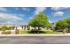 Charming single-story home featuring manicured lawn, mature tree, and covered entry at 3356 E Vallejo Ct, Gilbert, AZ 85298