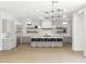 Modern kitchen features a large island with seating and stylish light fixture at 3356 E Vallejo Ct, Gilbert, AZ 85298