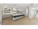 Spacious modern kitchen features a large island with seating, pendant lights, and wood floors at 3356 E Vallejo Ct, Gilbert, AZ 85298