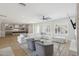 Spacious living room with white sectional sofa, cozy chairs, and view to the kitchen with breakfast bar at 3356 E Vallejo Ct, Gilbert, AZ 85298