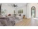 Spacious living room featuring a large sectional sofa, wood-look floors, and arched doorway at 3356 E Vallejo Ct, Gilbert, AZ 85298