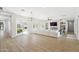 Bright living room features wood floors, built-in shelves, fireplace, and large sliding door to patio at 3356 E Vallejo Ct, Gilbert, AZ 85298