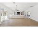 Expansive living room with wood floors, modern lighting, and large windows offering natural light at 3356 E Vallejo Ct, Gilbert, AZ 85298