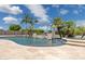 Luxury pool with stone waterfall feature, palm trees and patio at 3356 E Vallejo Ct, Gilbert, AZ 85298