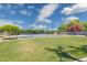 Backyard tennis and basketball court under blue skies with mature trees at 3356 E Vallejo Ct, Gilbert, AZ 85298