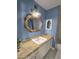 A stylish bathroom featuring blue walls, granite countertops, and a tub with shower at 3722 E Glade Ave, Mesa, AZ 85206