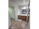 Bright bathroom features a double vanity, large mirror, and a tiled shower with a glass door at 3722 E Glade Ave, Mesa, AZ 85206