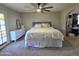 A bright bedroom featuring a large bed and a door to the outside at 3722 E Glade Ave, Mesa, AZ 85206