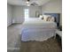 A bright bedroom featuring a large bed and a door to the outside at 3722 E Glade Ave, Mesa, AZ 85206
