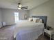 A bright bedroom featuring a large bed and a door to the outside at 3722 E Glade Ave, Mesa, AZ 85206