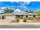 Charming single-story home with a well-maintained front yard and a two-car garage, under a partly cloudy sky at 3722 E Glade Ave, Mesa, AZ 85206