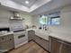 Updated kitchen boasts stainless steel appliances, white countertops, and farm sink at 3722 E Glade Ave, Mesa, AZ 85206