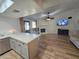 Spacious living room featuring a brick fireplace and seamless flow from the kitchen at 3722 E Glade Ave, Mesa, AZ 85206
