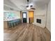 Open-concept living room with fireplace, kitchen bar, and wood-look flooring at 3722 E Glade Ave, Mesa, AZ 85206
