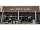 AJ's Fine Foods storefront with umbrella-covered outdoor seating, beckoning shoppers to a gourmet experience at 540 W Mariposa St # 9, Phoenix, AZ 85013