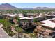 Stunning aerial view of condo building with lush landscaping, mountain views, and multiple balconies at 7131 E Rancho Vista Dr # 1008, Scottsdale, AZ 85251