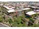 Aerial view of condos surrounded by lush greenery in an urban environment close to shopping at 7131 E Rancho Vista Dr # 1008, Scottsdale, AZ 85251