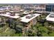 An aerial perspective shows a modern condo complex with terraces filled with plants and trees at 7131 E Rancho Vista Dr # 1008, Scottsdale, AZ 85251