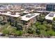 A high-angle drone view captures the unique architectural design and lush landscaping of this condo complex at 7131 E Rancho Vista Dr # 1008, Scottsdale, AZ 85251