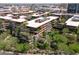 A high-angle drone view captures the unique architectural design and lush landscaping of this condo complex at 7131 E Rancho Vista Dr # 1008, Scottsdale, AZ 85251