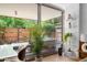 Large window looks out to a secluded private balcony surrounded by mature trees and landscaping at 7131 E Rancho Vista Dr # 1008, Scottsdale, AZ 85251
