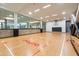 Indoor basketball court featuring hardwood floors and large viewing windows at 7131 E Rancho Vista Dr # 1008, Scottsdale, AZ 85251