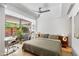 Bright bedroom features a large window, ceiling fan, and modern decor at 7131 E Rancho Vista Dr # 1008, Scottsdale, AZ 85251