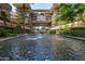Attractive water fountain feature with lush landscaping against a background of luxury condominiums at 7131 E Rancho Vista Dr # 1008, Scottsdale, AZ 85251