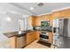 Bright kitchen featuring stainless steel appliances, black countertops, and sleek cabinetry at 7131 E Rancho Vista Dr # 1008, Scottsdale, AZ 85251