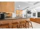 Modern kitchen with eat-in breakfast bar, stainless appliances, mosaic backsplash, and modern lighting at 7131 E Rancho Vista Dr # 1008, Scottsdale, AZ 85251