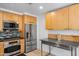 Modern kitchen boasts stainless appliances, wooden cabinets, and stylish backsplash, perfect for cooking and entertaining at 7131 E Rancho Vista Dr # 1008, Scottsdale, AZ 85251