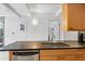 Well-equipped kitchen with a stainless steel sink, wooden cabinets, and black countertops at 7131 E Rancho Vista Dr # 1008, Scottsdale, AZ 85251