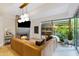 Bright living room with a modern fireplace and floor-to-ceiling windows overlooking the lush patio at 7131 E Rancho Vista Dr # 1008, Scottsdale, AZ 85251