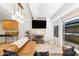 Bright living room featuring contemporary design, modern fireplace, and stylish lighting with a glimpse of the kitchen at 7131 E Rancho Vista Dr # 1008, Scottsdale, AZ 85251