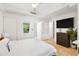 A contemporary main bedroom, with white walls, a ceiling fan, and exterior views at 7131 E Rancho Vista Dr # 1008, Scottsdale, AZ 85251