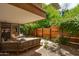 Covered patio with outdoor seating overlooking lush backyard landscaping at 7131 E Rancho Vista Dr # 1008, Scottsdale, AZ 85251
