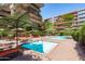 Relaxing pool area with lounge chairs and umbrellas by well-maintained landscaping at 7131 E Rancho Vista Dr # 1008, Scottsdale, AZ 85251