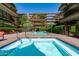 Upscale pool area surrounded by lush landscaping in courtyard setting at 7131 E Rancho Vista Dr # 1008, Scottsdale, AZ 85251