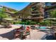 Outdoor pool area features comfortable seating and lush landscaping with building views at 7131 E Rancho Vista Dr # 1008, Scottsdale, AZ 85251