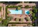 Aerial shot of a private community pool area offering shade, seating, and mature landscaping at 7131 E Rancho Vista Dr # 1008, Scottsdale, AZ 85251