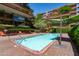 Community pool featuring lounge chairs and green umbrella shading for residents at 7131 E Rancho Vista Dr # 1008, Scottsdale, AZ 85251