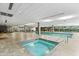 Inviting indoor pool and spa area with lounge chairs and tile flooring at 7131 E Rancho Vista Dr # 1008, Scottsdale, AZ 85251