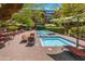 Serene pool and jacuzzi area with lounge chairs, tables, and umbrellas, perfect for relaxation at 7131 E Rancho Vista Dr # 1008, Scottsdale, AZ 85251