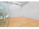 Bright racquetball court featuring hardwood floors and glass viewing wall at 7131 E Rancho Vista Dr # 1008, Scottsdale, AZ 85251